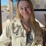 smiling woman sitting in a diner